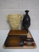 A tray containing a carved tribal bust,