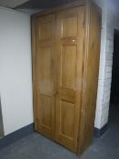 A large pine double door cupboard fitted with shelves CONDITION REPORT: 223cm high