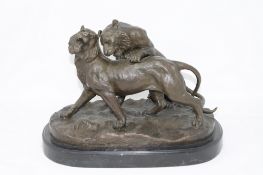 A contemporary bronze figure of two lions at play, signed Walton, purchased from The Bronze Gallery,