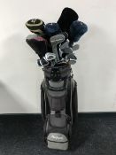 A golf bag containing a quantity of assorted irons and drivers together with a folding golf trolley