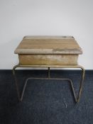 A mid 20th century school desk on tubular metal legs