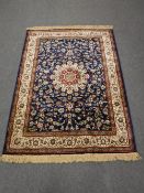 A machine made rug of Nain design, 195cm by 134cm.