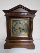 An early 20th century mahogany bracket clock with brass and silvered dial.