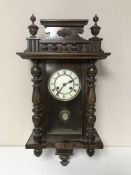 An oak cased eight day wall clock