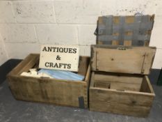 Two stripped pine boxes containing an antique centre sign and pieces of wood