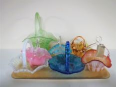 A tray of eight coloured glass baskets