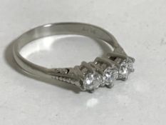 A platinum three stone diamond ring