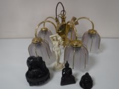 A brass five way light fitting with glass shades together with three Eastern hardwood figures and a