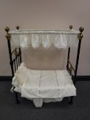 A Victorian cast iron and brass doll's canopy bed, length 89cm.