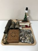 A tray containing antique glass oil lamp, assorted cutlery, pair of field glasses,