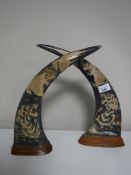 A pair of carved eastern buffalo horns on plinths (2)