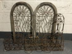Six metal flower pot trellises together with a metal candle sconce