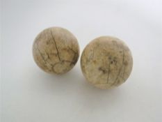 Two antique ivory bowling jacks