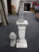 A plaster style column together with a figure of an owl and kestrel