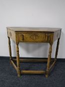 An early 20th century oak hall table fitted a drawer
