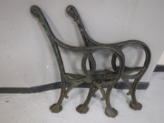 A pair of antique cast iron bench ends