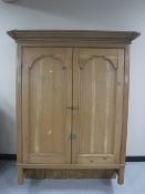 A pine wall mounted cupboard