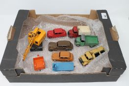 A box containing original Dinky die cast vehicles including a 23A Packard Super 8 Tourer,