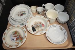 A tray containing eleven pieces of Royal Doulton Bunnykins and Wedgwood Peter Rabbit china