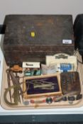 An antique pine box containing a small quantity of hand tools, precision drawing instruments,