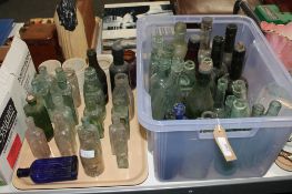 A tray and a box containing a quantity of antique glass bottles and pots