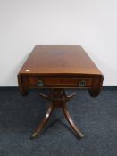 A Victorian inlaid mahogany pedestal sofa table fitted a drawer