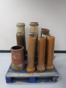 A pallet containing assorted 20th century chimney pots and ground pipes