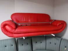 A contemporary red leather settee on chrome legs