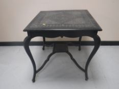 An early twentieth century carved ebonised occasional table
