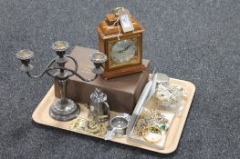A tray containing a boxed Garrard & Company Elliott mantel clock together with plated wares,