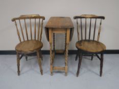 An oak barley twist drop leaf table together with a pair of Ibex kitchen chairs