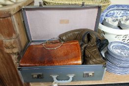 A vintage suitcase containing a Harrods jacket,