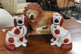 A pair of Staffordshire dogs together with a Staffordshire lion