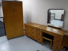 A four piece oak bedroom suite comprising of double door wardrobe,