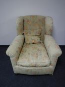A Victorian style wingback armchair upholstered in a floral fabric, width 92cm.