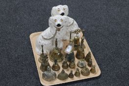 A pair of Staffordshire dogs together with a collection of brass bells