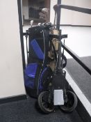 A golf bag containing vintage golf clubs together with a M.D.