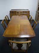 An eight piece walnut Strongbow dining room suite comprising of sideboard,