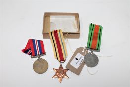 Three World War II medals with ribbons; Defence Medal,
