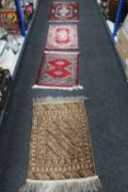 Three Eastern woollen rugs together with a floral patterned rug