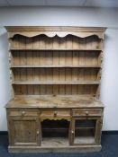 An early 20th century pine farmhouse kitchen dresser