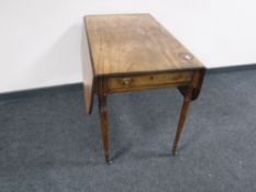 A George III mahogany drop leaf sofa table, on tapered legs terminating in brass castors,