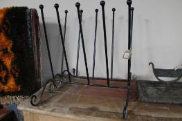 A wrought iron boot stand