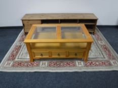 A pine glass topped coffee table fitted with drawers,