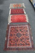 Four small fringed Eastern rugs