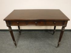 A Victorian rosewood side table on reeded legs fitted with a drawer