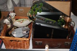 A vintage leather luggage case containing assorted board games, copper vase,