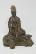 A Chinese bronze figure of a deity seated on an elephant