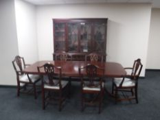 An eight piece inlaid mahogany Regency style dining room suite comprising of four door bookcase
