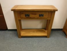 A contemporary oak hall table fitted with a drawer